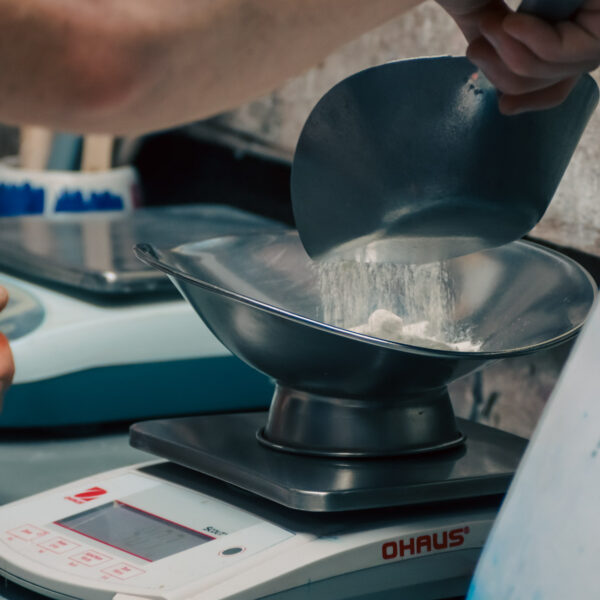 A Behind the scenes look at making glaze by weighing fine materials out.