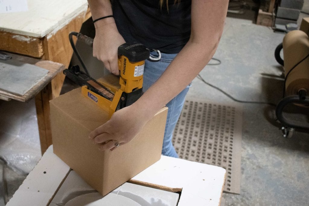 One of our workers is packaging an order in our recycled packaging. We use eco-friendly packaging every day, not just on Earth Day!