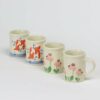 Selection of stoneware pottery Children's Cups in multiple glazes and hand-painted designs.