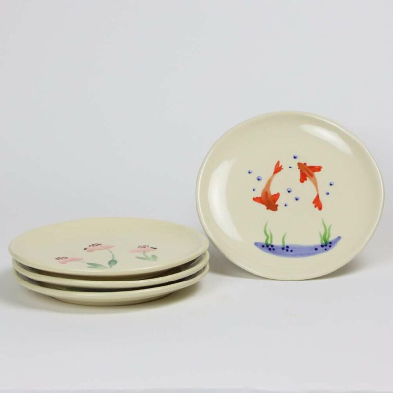 Selection of stoneware pottery Children's Plates in multiple glazes and hand-painted designs.