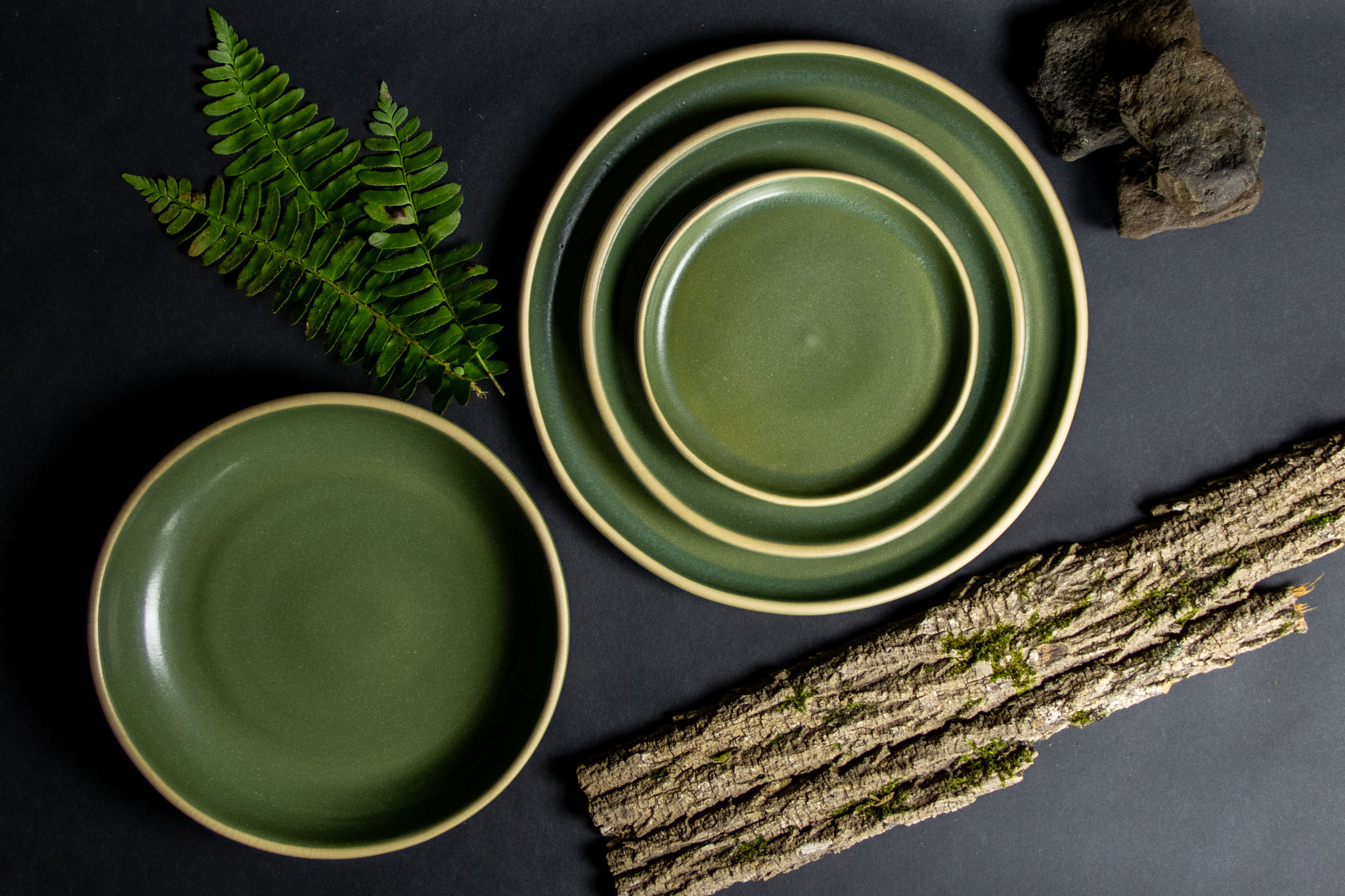 Moss Brookline Dinnerware Set with natural bark and ferns.