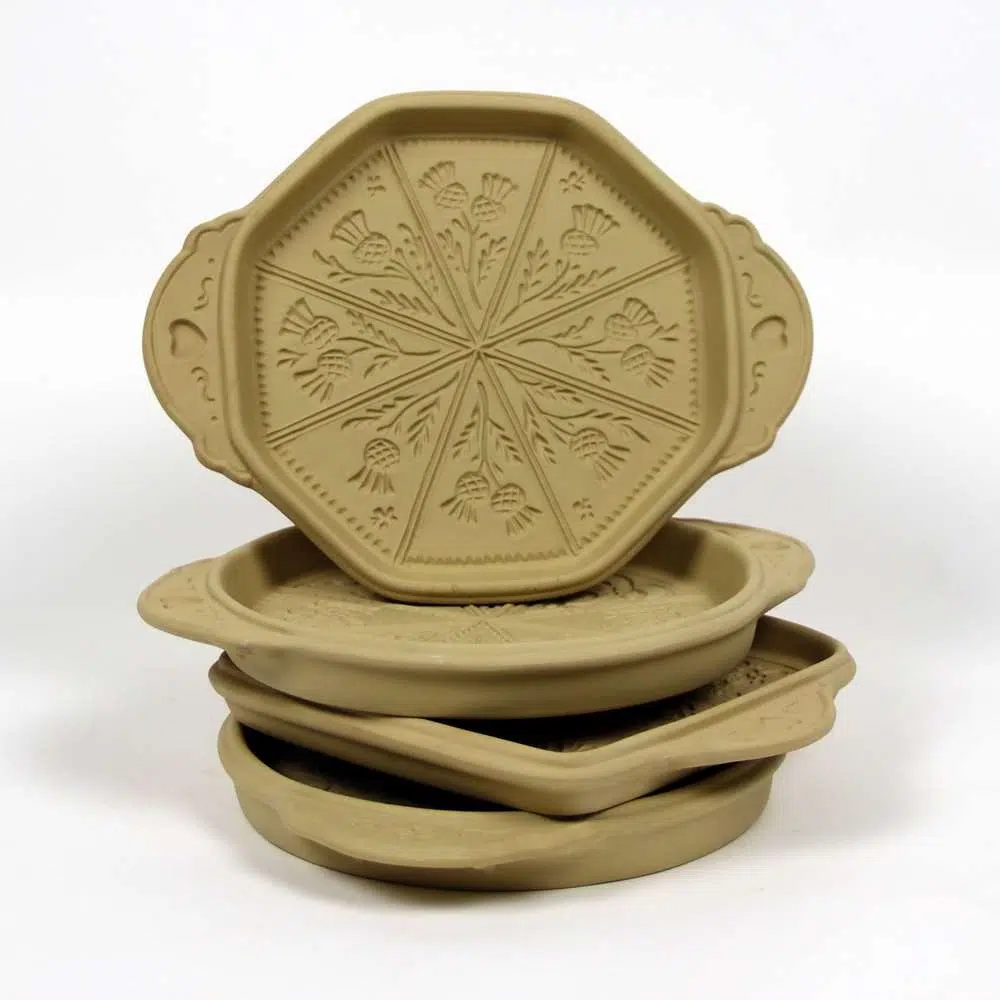 Selection of stoneware pottery Shortbread Pans in multiple shapes and shortbread designs.
